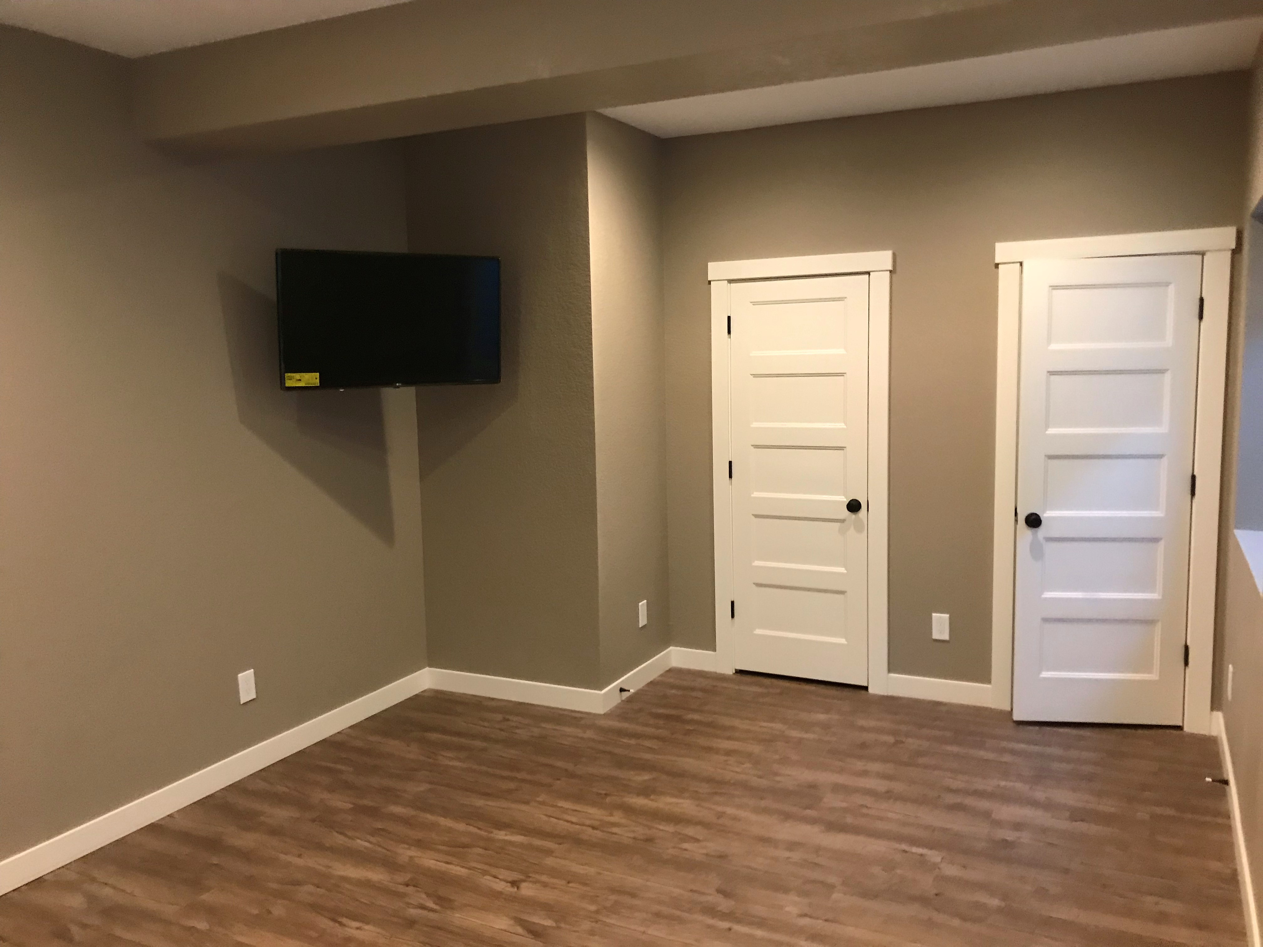 finished basment with hanging tv for workout room