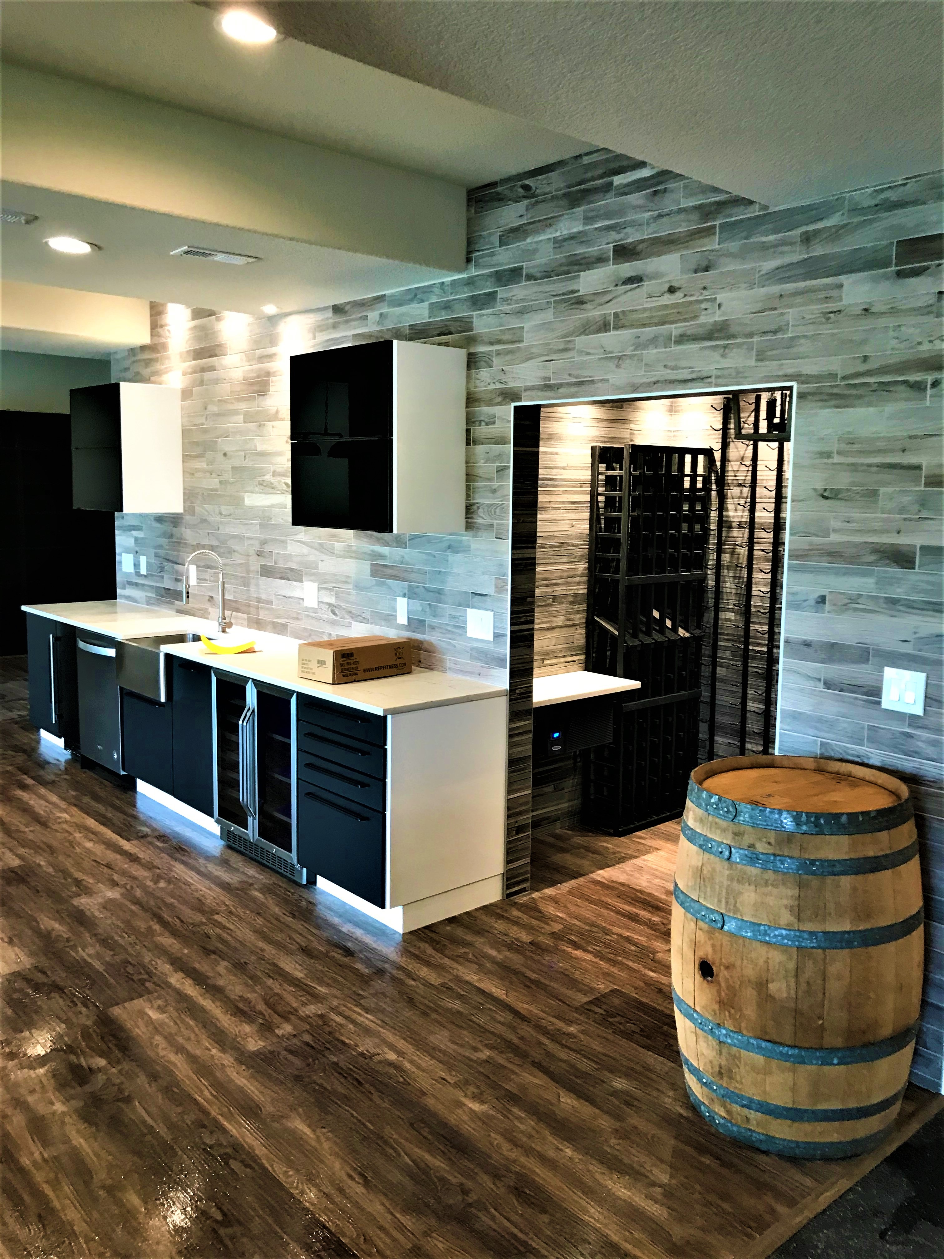 finished basement wet bar with entry to a wall room