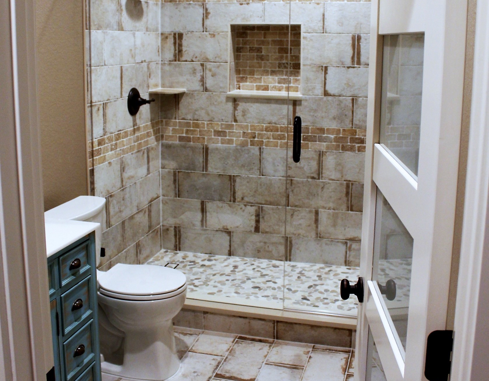 slightly closed door with the view of a shower