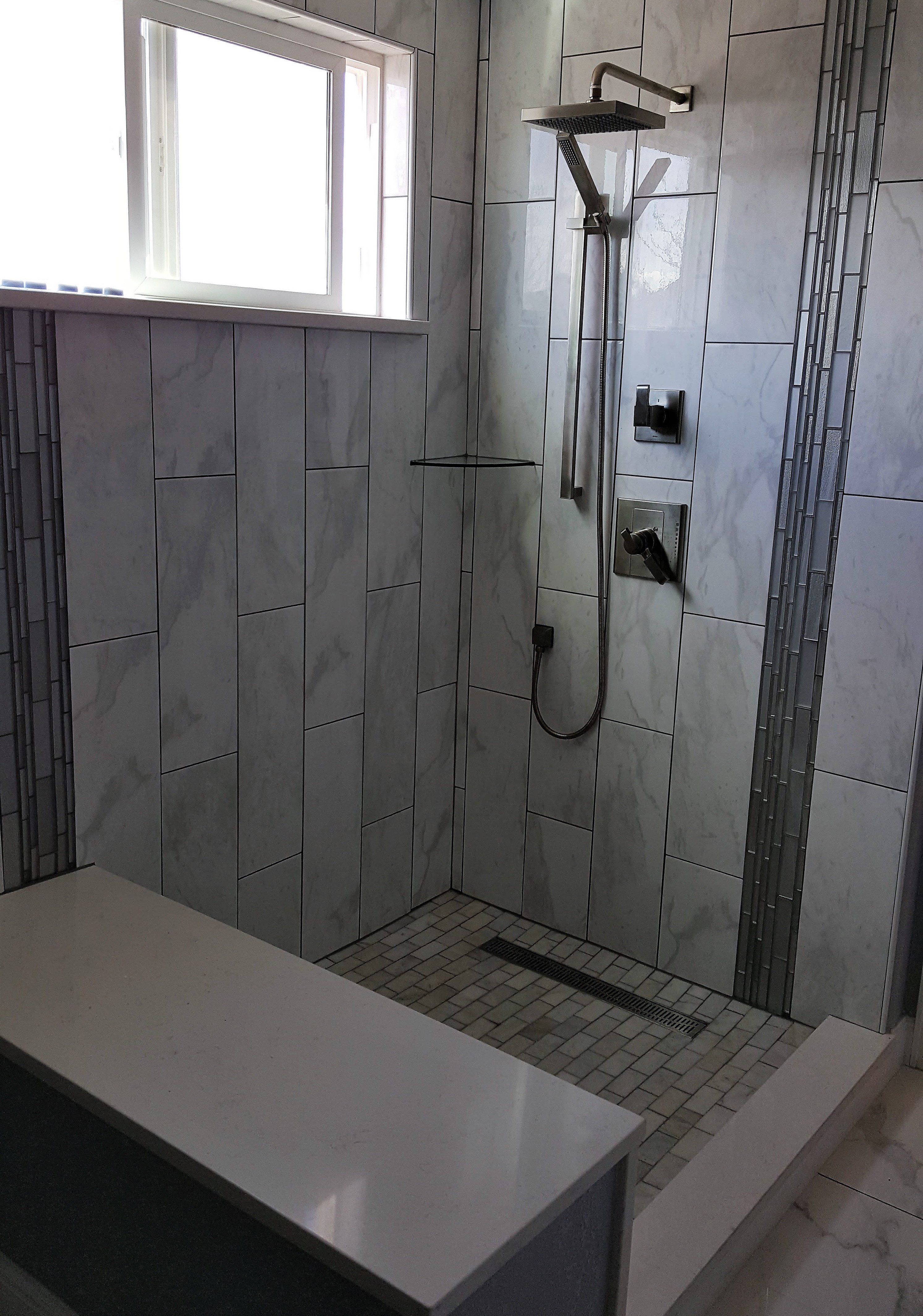 shower with a bench and multi shower fixture