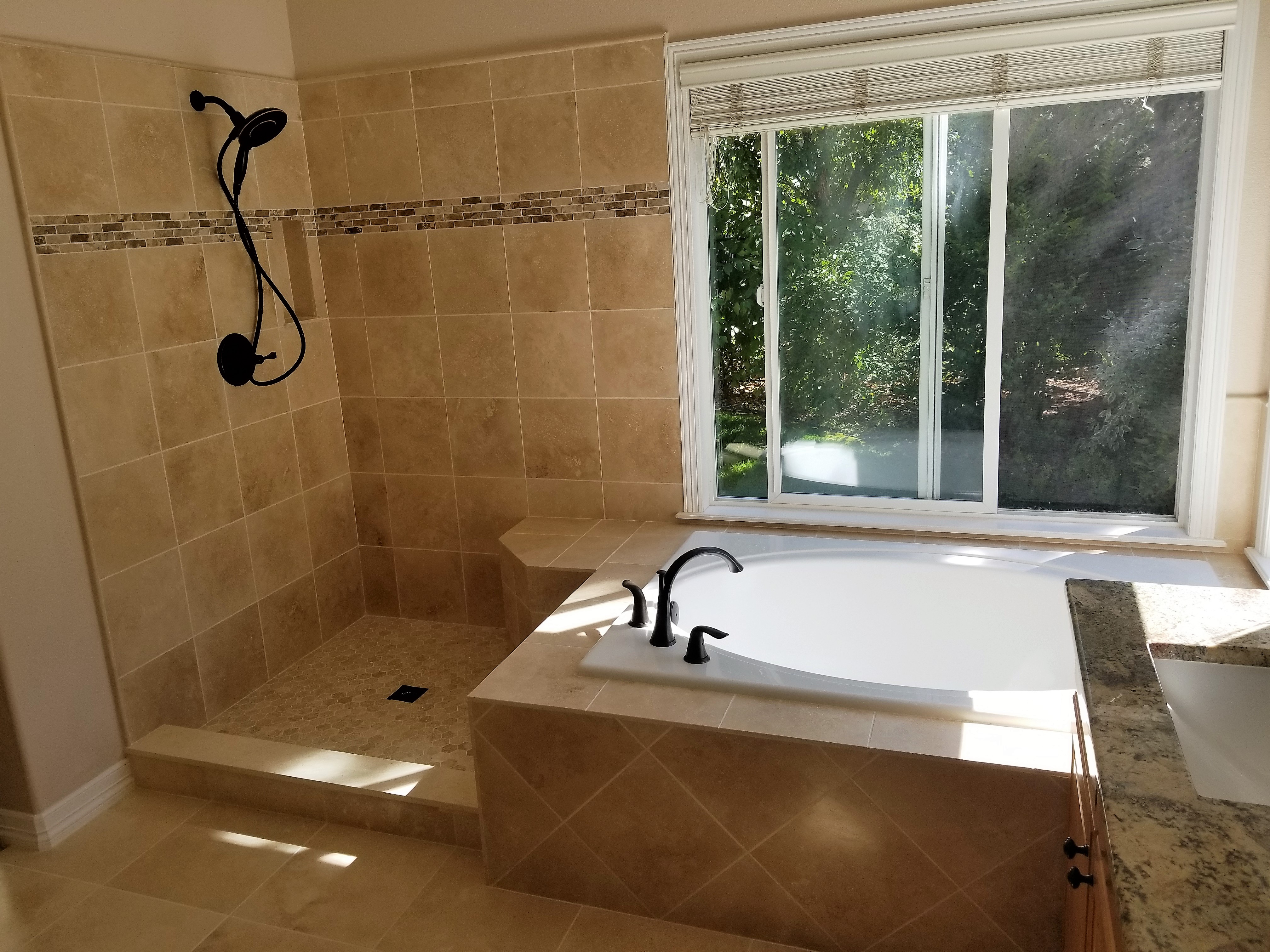 corner shower with a bathtub to the right