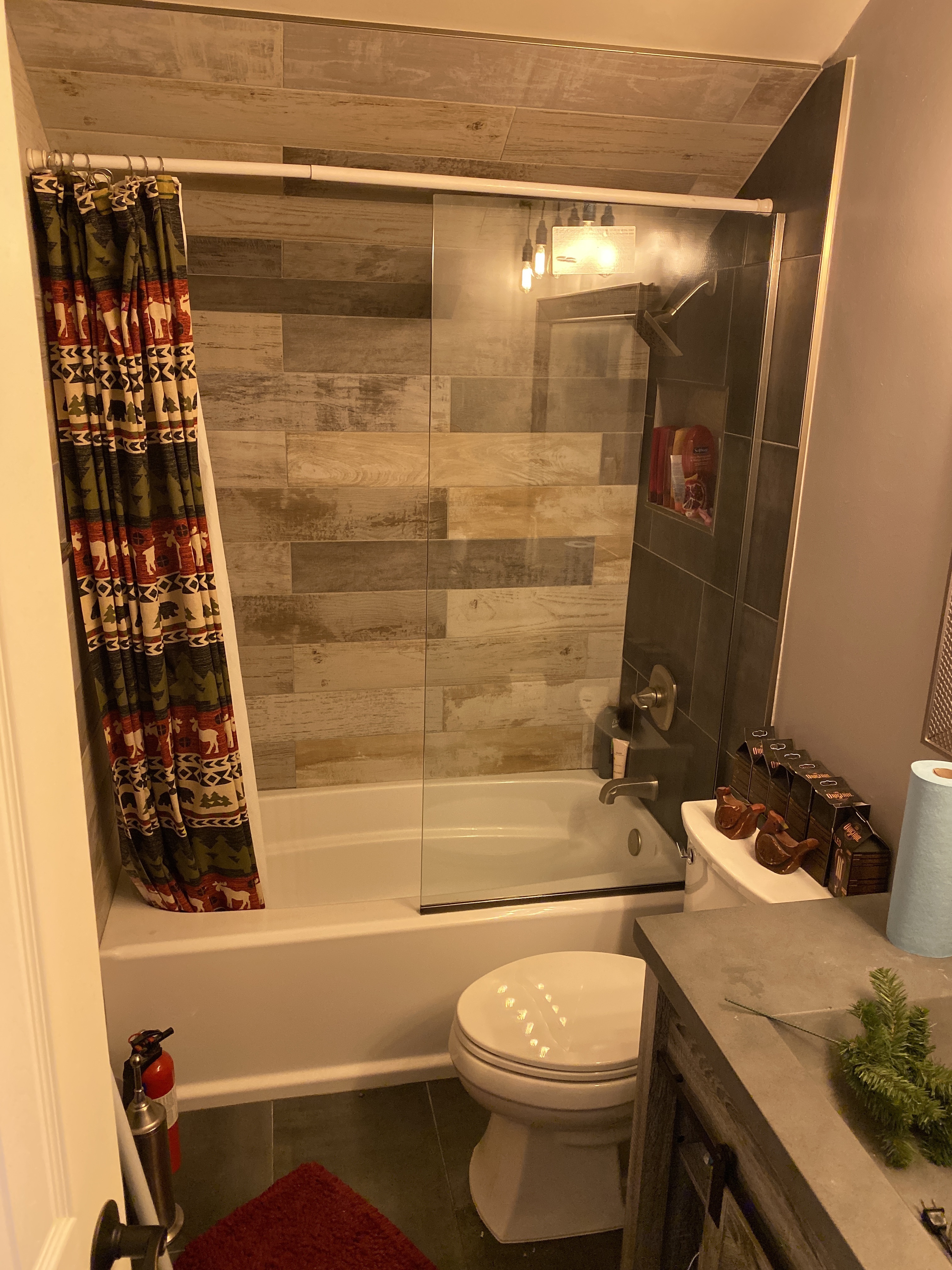 bathtub and a shower with tiles on the ceiling